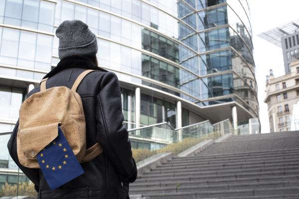 Young girl walking with EU flag on her ruck sack